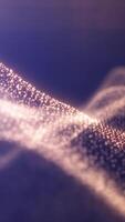 A soft wave of golden particles flowing over a purple background, evoking motion, harmony, and digital texture video