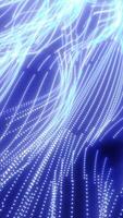 Dense streaks of glowing blue particles flow across the frame, forming a smooth, fluid motion video