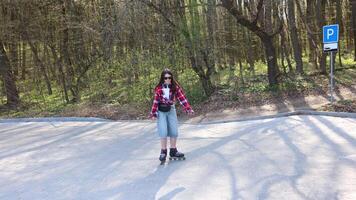 Girl roller skating in a park during spring enjoying a sunny day. video
