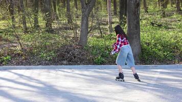 Teen girl roller skating in a park during spring enjoying a sunny day video