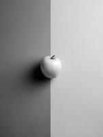 Grayscale Layout Featuring a Single Colored Apple Highlighting Minimalist Design in a Symmetrical Composition With a Contrasting Backdrop photo