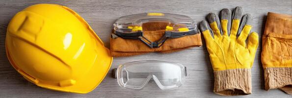 Safety Gear Flat Lay Featuring Hard Hat, Safety Gloves, and Goggles on a Neutral Backdrop Suitable for Construction and Industrial Activities photo