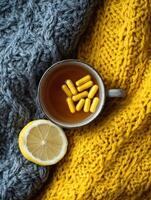 Cozy Setting With a Cup of Tea and Vitamins on a Knitted Texture Background During a Quiet Afternoon photo