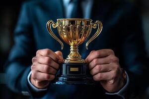 Celebration of Achievement With a Golden Trophy Held in a Suit. photo