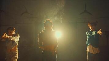 Group of people dancing in a room with atmospheric back light and dust particles video