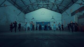 Group of people dancing in a dimly lit room, motion blur, expressing joy and movement. video