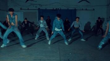 Group of people dancing in a dimly lit room, motion blur, expressing joy video