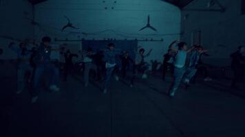 Silhouettes of people in a dark, moody room with atmospheric lighting, suitable for themes of mystery video