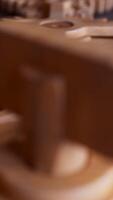 Looping animation of a mechanical construction made of wooden gears. Cyclic movement. Close-up. Vertical composition. video