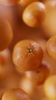 Animation of a group of mandarin. Many tangerines slowly rotate in the background in space. Vertical composition. Defocus. video