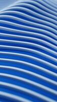 White geometric lines smoothly wave in perspective and soft focus, creating a calm, abstract motion over a blue background. Perfect for tech, design, or futuristic visuals. video