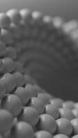 Looped animation of a close-up Mobius shape made of glossy white spheres. Smooth rotation with soft focus and shallow depth of field. Perfect for abstract, tech, or modern design themes. video