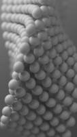Abstract 3D loop white spheres arranged in a Mobius shape, rotating continuously. Soft focus and close-up view add depth and a futuristic touch. video