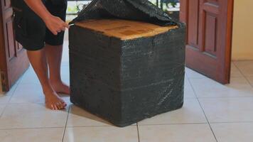 Person Carrying a Large Wrapped Package Indoors video