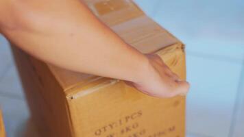 Person Opening a Cardboard Box with a Knife video