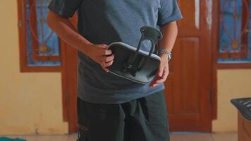 Person Holding a Modern Portable Speaker in a Casual Setting video