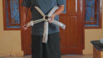 Person Assembling a Metallic Object in a Room video