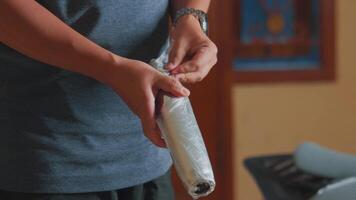 Person Holding a Metallic Tool in Indoor Setting video