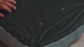 Textured Black Fabric Surface with Stitching and Holes video