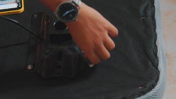 Hand Adjusting Metal Bracket on Fabric Surface video
