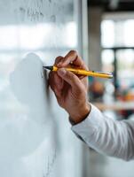 Teacher Writing on Whiteboard in Classroom, Illustrating Concepts for Engaged Students During Lesson Time photo