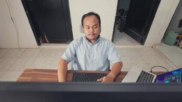 Focused Man Working at a Desk with Laptop video