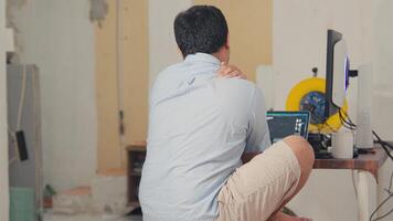 Man Working on Laptop in Renovated Room video