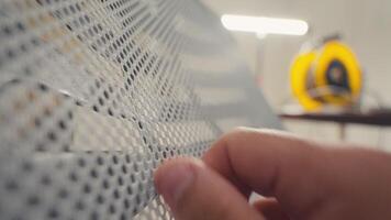 Hand Touching Metal Mesh Surface in Workshop video