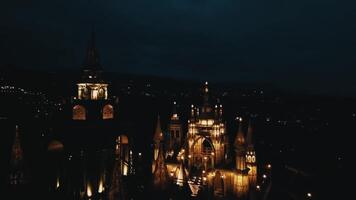 A beautifully illuminated castle at night, showcasing intricate architecture and glowing lights against a dark sky. The scene evokes a sense of wonder and magic. video