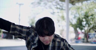 Handheld selective focus shot, Stylish Asian man with dancing skills, moving body coolly and stylishly to the rhythm. video
