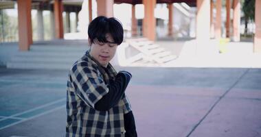 Handheld shot, Young Asian man with dancing skills is practicing new moves by himself. Solo dance. video