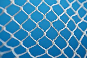 Close-up of White Netting Against a Vibrant Blue Background. A detailed texture image perfect for design projects. photo