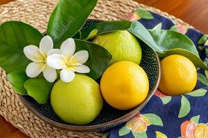 Fresh Citrus Fruits with Plumeria Blossoms in a Decorative Bowl. A vibrant still life image perfect for culinary, wellness, or tropical themes. photo