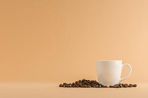 A Simple Still Life Coffee Beans and a White Mug. This image offers a clean and minimalist design perfect for branding or website use. photo