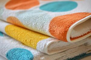 Stack of Colorful Dotted Bath Towels Soft, Absorbent Fabric Close-Up. photo