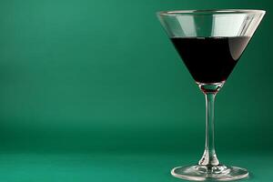 A Glass of Red Wine Against a Green Background Elegant Still Life Photography. photo