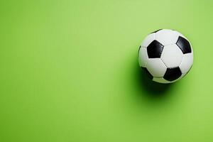 Soccer Ball on Green Background Copy Space for Sports Design. A classic black and white football rests on a vibrant green backdrop, perfect for sports-related designs. photo