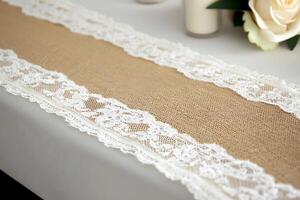 Elegant Burlap Table Runner with Delicate Lace Trim Perfect for Wedding or Rustic Event Decor. photo
