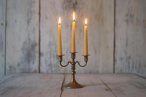 Three Lit Candles on Antique Brass Candelabra. A rustic, elegant image perfect for home decor, relaxation, and spirituality. photo