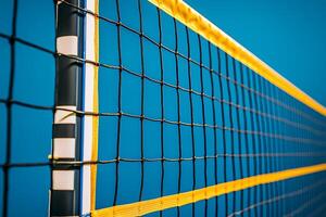 Close-up of a Volleyball Net Against a Vibrant Blue Sky. The image showcases the intricate details and bright colors of the sports equipment. photo