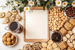 Flatlay of assorted cookies, coffee, and flowers with a blank card for copy space. photo