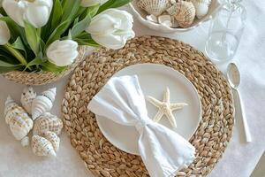 Elegant Coastal Table Setting with White Tulips and Seashells. photo