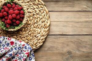 Rustic Still Life Raspberries in a Woven Basket on Wooden Background. photo