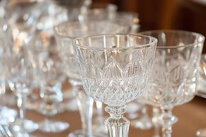Close-up of Elegant Crystal Glasses on a Table Setting. A Detailed Image of Sparkling, Cut-Glass Drinkware. photo