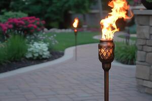 Illuminated Garden Path Bronze Torch with Flaming Detail. photo