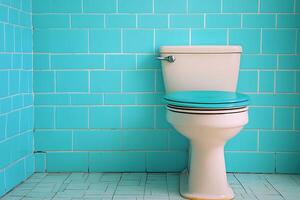 Retro Bathroom Toilet with Teal Tile Walls. A vintage-style toilet with a teal seat sits against a backdrop of turquoise tiled walls. photo