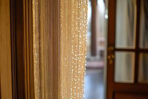Sparkling Beaded Curtain Dividing Interior Space. A close-up image showing shimmering strands of beads creating a luxurious room divider. photo