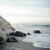 Serene Coastal Scene Rocks and Waves at Dawn. A tranquil image of the ocean meeting the shore. photo
