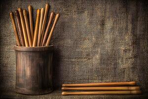 Wooden Dowels in Rustic Container Against Burlap Background A Still Life Image. photo