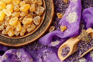 Aromatic Amber Resin and Dried Lavender Flowers on Purple Fabric. A Still Life Featuring Natural Ingredients. photo
